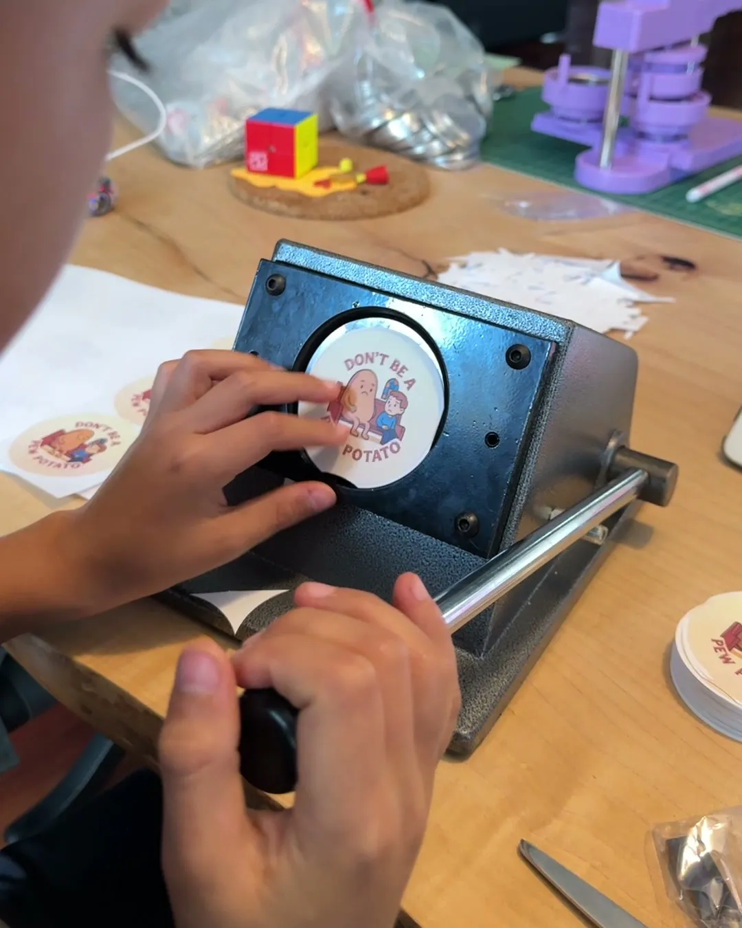 Hands pulling a button press lever